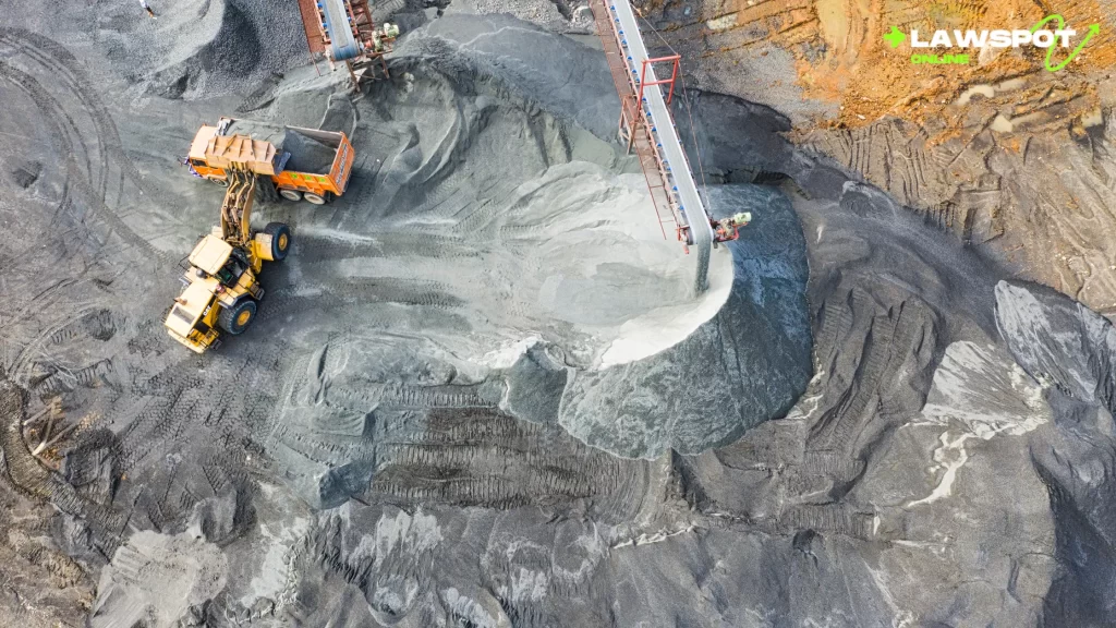 Can you have your own mining company? Overhead view of a mining site with heavy machinery loading raw materials onto trucks.