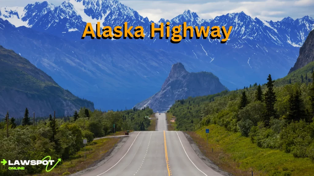 A scenic view of the Alaska Highway, surrounded by lush greenery and snow-capped mountains in the distance. Can you drive to Alaska? Yes, and this iconic highway is one of the most beautiful routes to take.